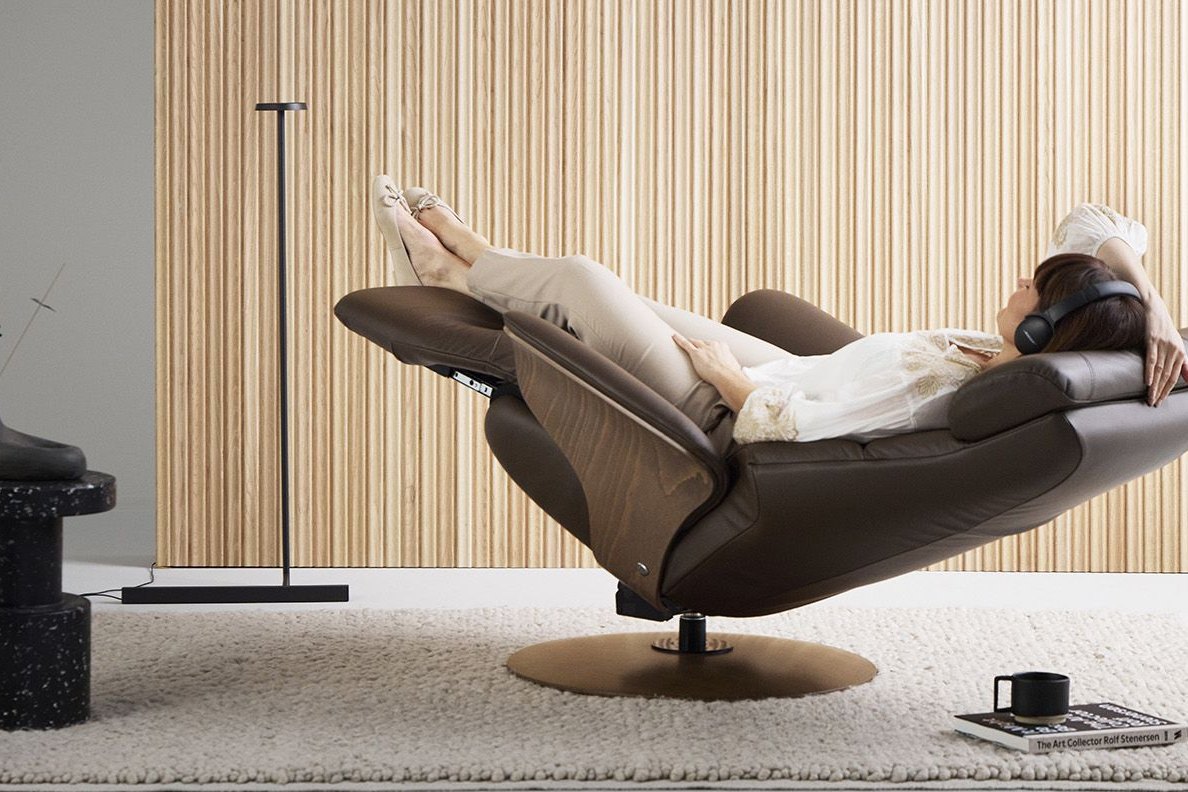 Woman fully reclined in a Stressless Adam power recliner