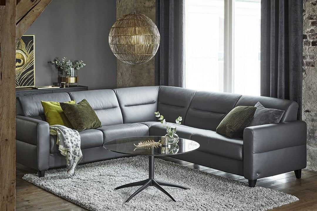 Stressless Fiona sectional sofa in dark grey leather in a styled living room