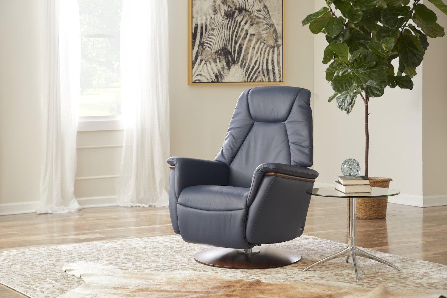 Stressless Max power recliner in dark blue leather in a sunlit living room