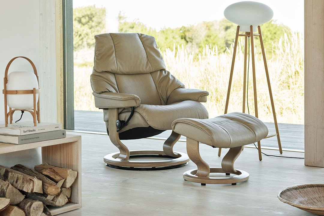 Stressless Reno recliner and ottoman in light leather in a sunlit room