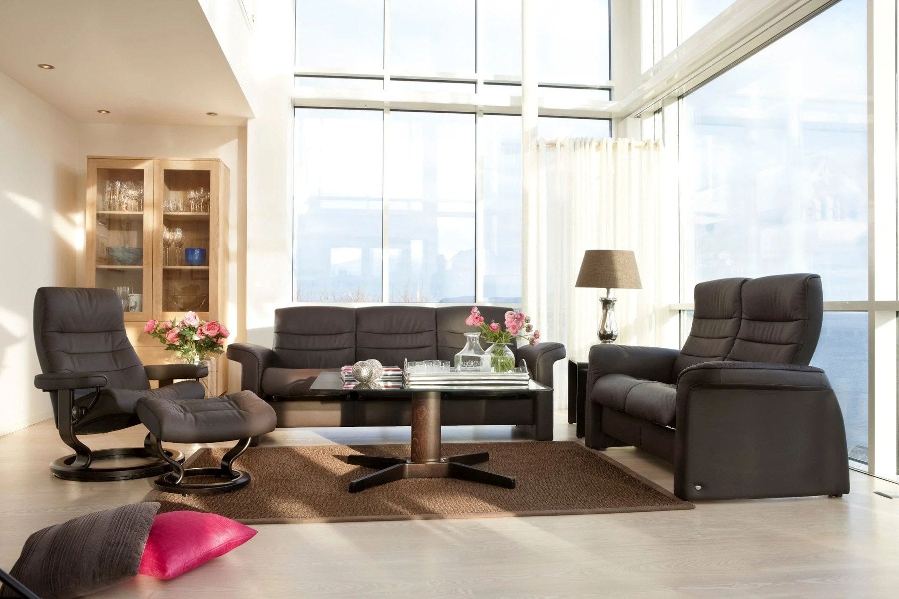 Stressless Sapphire leather sofa and matching recliners arranged in a bright living room