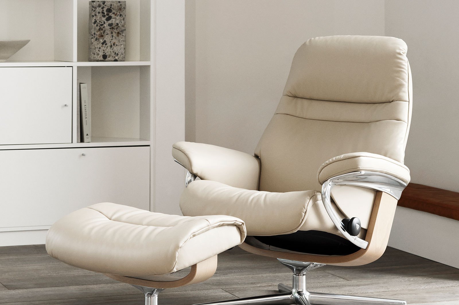 Stressless Sunrise recliner and ottoman with Cross base in cream leather