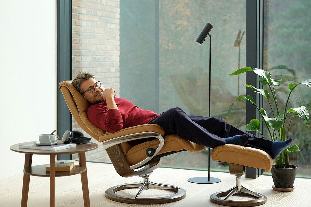 Relaxing with feet up in a Stressless View Signature recliner in Paloma Taupe leather