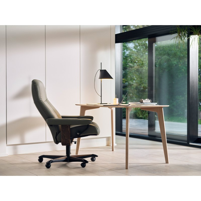Stressless Consul home office chair in green leather at a wooden desk