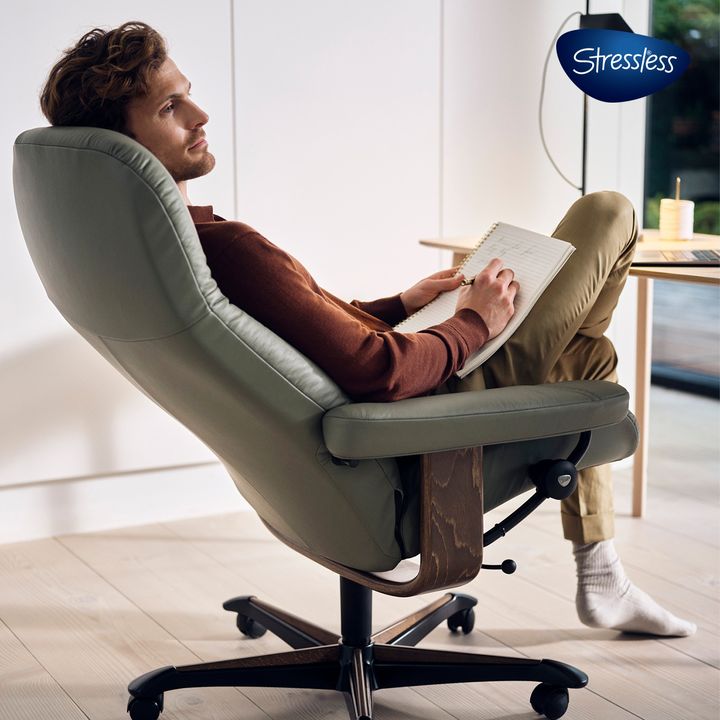 Man relaxing with a notebook in a Stressless Consul home office chair, close-up