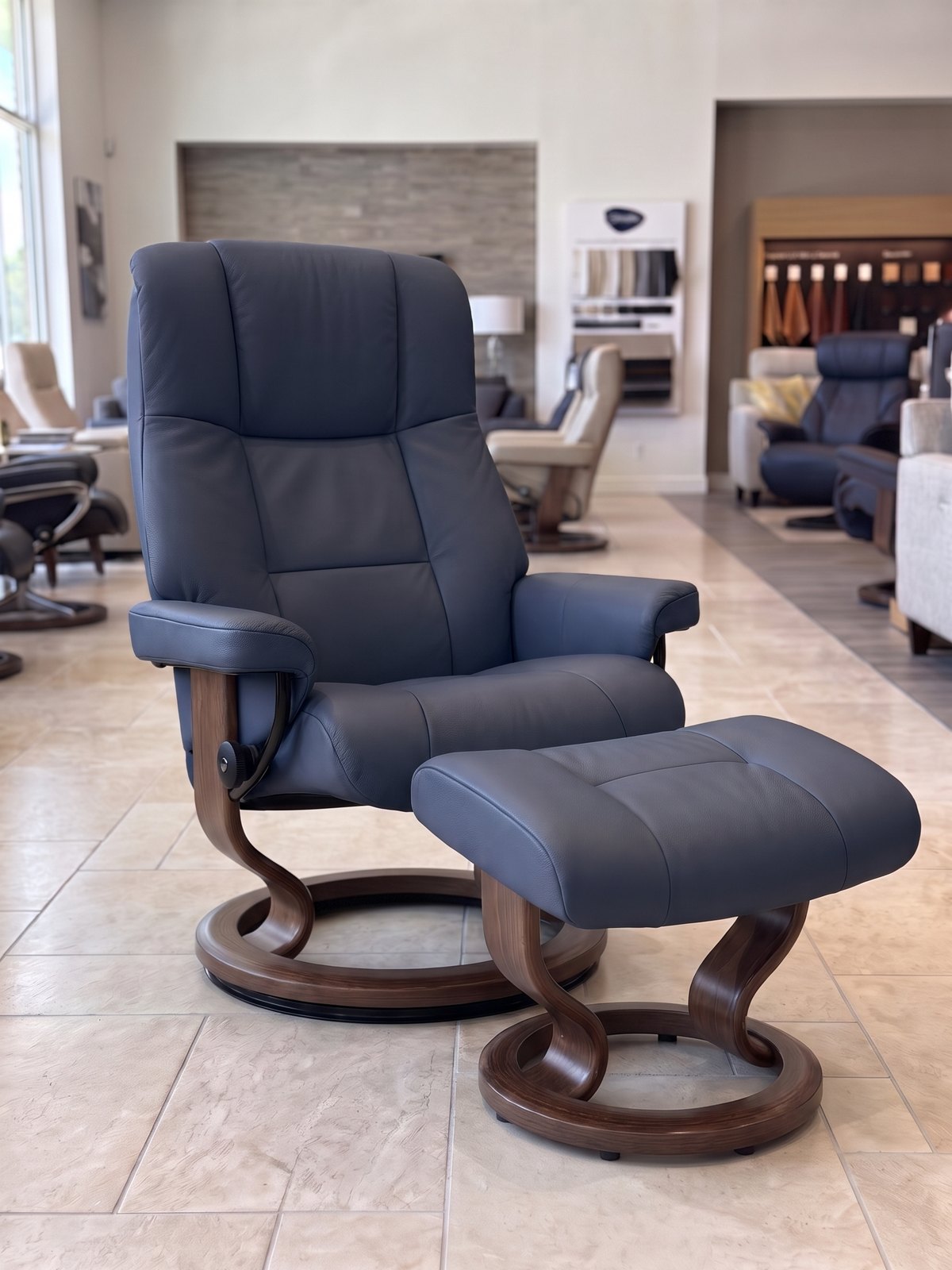 Stressless Mayfair Large Classic recliner and ottoman in Paloma Oxford Blue leather with a Brown stain Classic base, In-Stock Special at Haynes Comfort