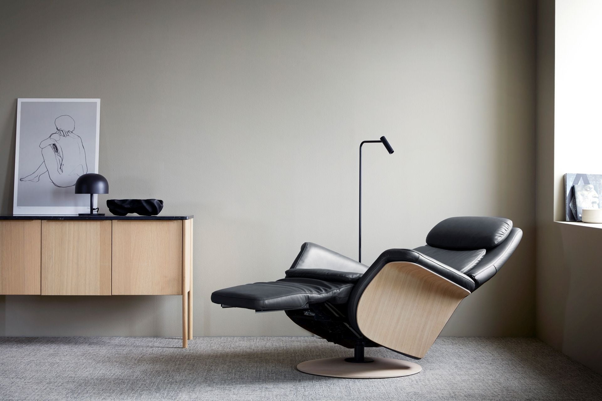 The Stressless Sam Medium Power recliner in Paloma leather with Oak wood.